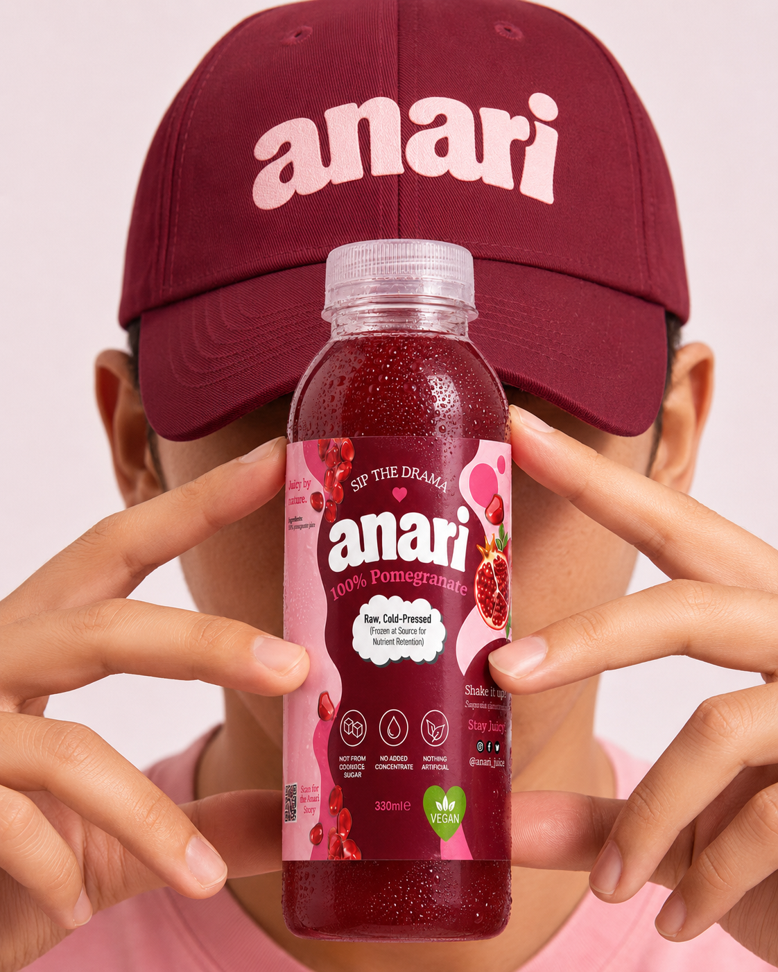 ANARI bottle held in front of a burgundy ANARI cap